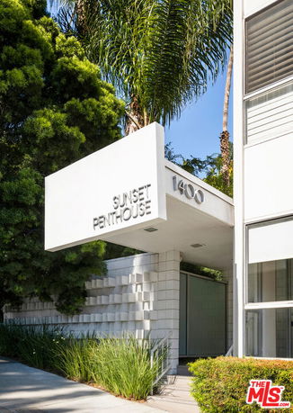 Front view of a building entrance labeled 'Sunset Penthouse'.