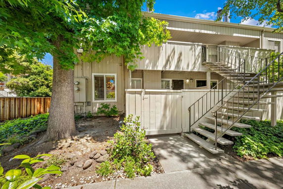 Front view of a two-story building with an external staircase.