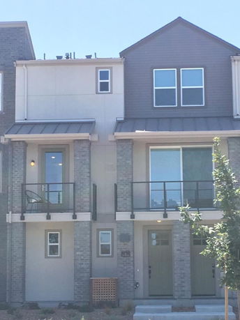 Front view of a modern two-story townhouse with balconies.