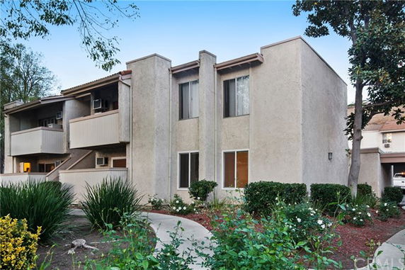 Front view of a multi-story residential building with balconies.