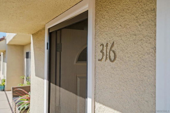 Front view of a building door with the number 316.