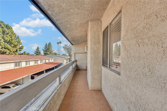 View from a balcony overlooking rooftops and trees.