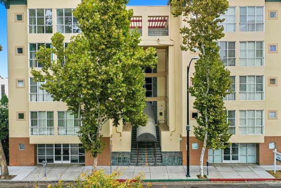 Front view of a multi-story building with large windows and a central entrance.