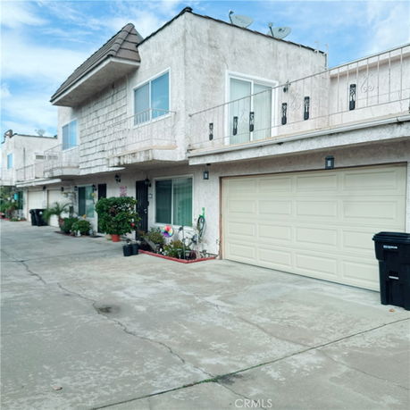 Front view of a house with a double garage and balconies.