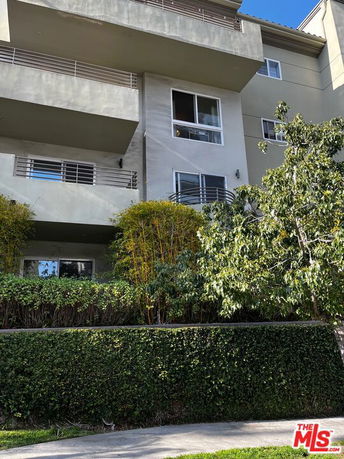 Front view of a multi-story residential building with balconies.
