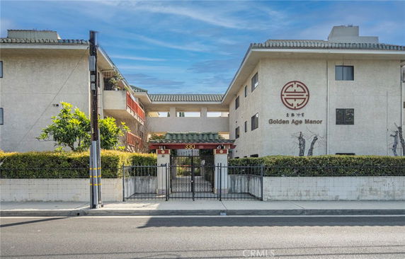 Front view of a multi-story building with signage 'Golden Age Manor'.