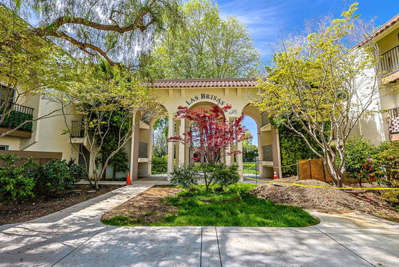 Front view of a building entrance with an archway labeled 'Las Brisas'.