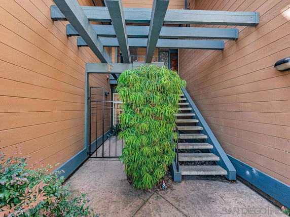 Exterior view of a building with a staircase leading to an entrance.