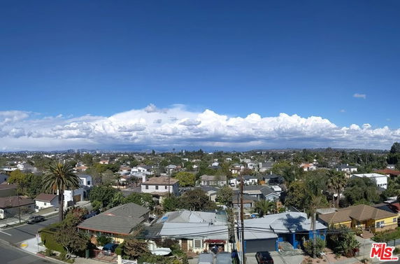 Panoramic view of a suburban area with houses and a clear sky.