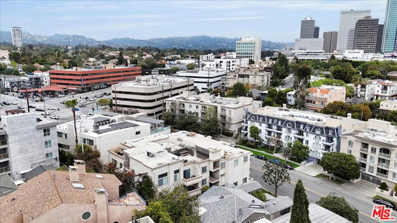 Panoramic view of a cityscape with multiple residential and commercial buildings.