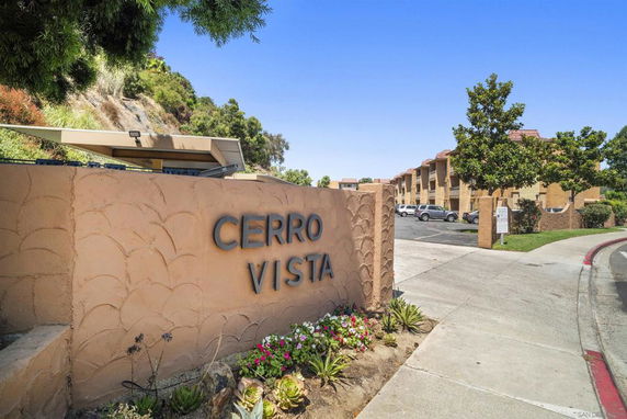 Front view of a residential building complex with a sign reading 'Cerro Vista'.