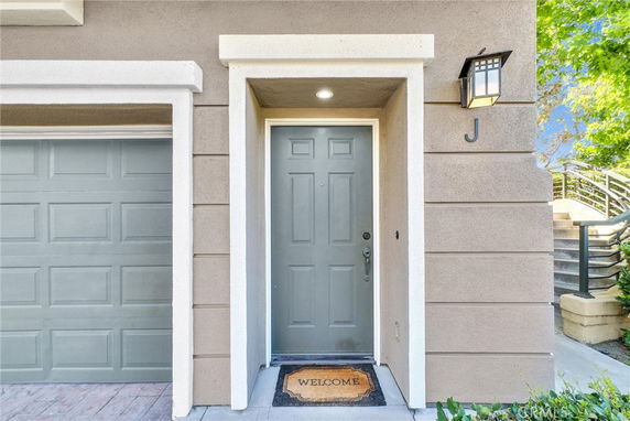 Front view of a house entrance with a green door and garage.