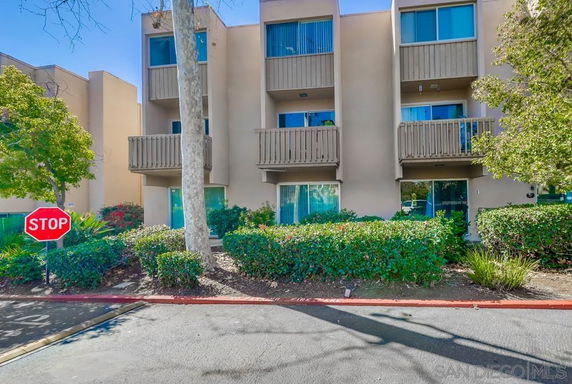 Front view of a multi-story residential building with balconies.