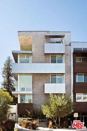 Front view of a contemporary multi-story apartment building.