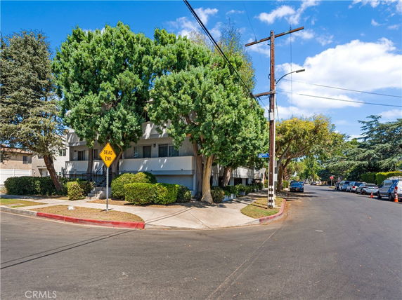 Front view of a residential building on a street corner.