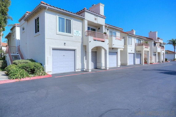 Front view of a row of two-story houses with attached garages.