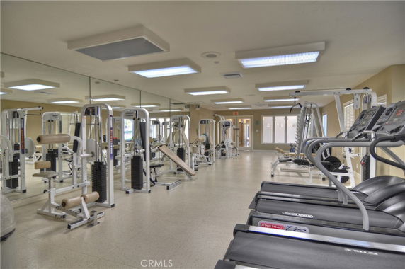 Indoor gym with various exercise equipment and treadmills.