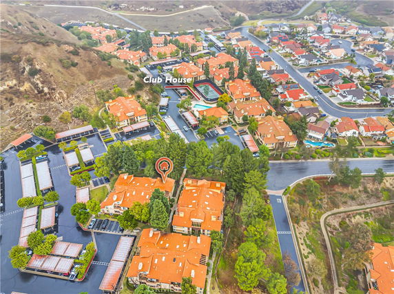 Elevated view of a residential area with multiple houses and a clubhouse.