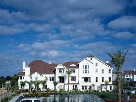 Front view of a large multi-story building with brown roofs.