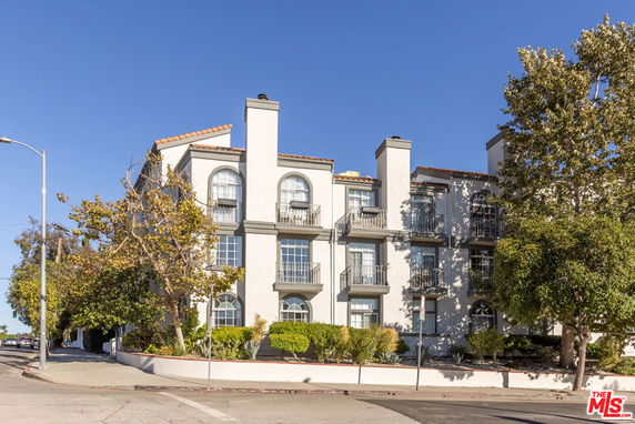 Front view of a multi-story building with balconies.