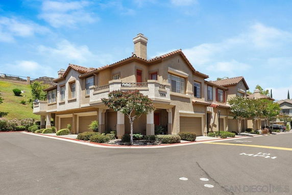 Front view of a two-story residential building with multiple garages.
