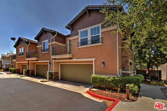 Front view of a two-story townhouse with garages.