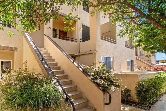 Front view of a multi-story residential building with stair access.