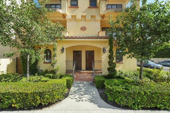 Front view of a multi-story house with a Mediterranean style entrance.