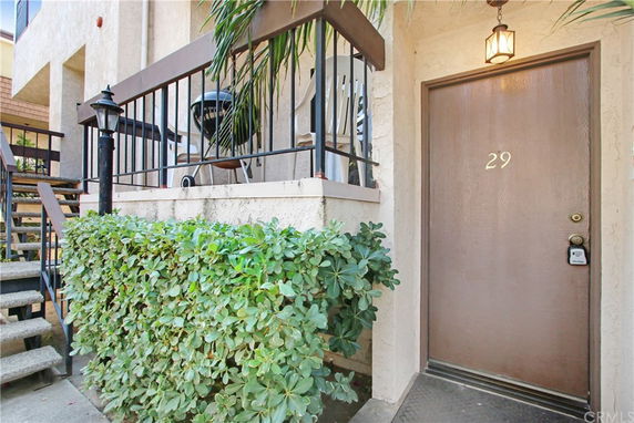 Elevated entry view with door labeled 29 and adjacent stairs.