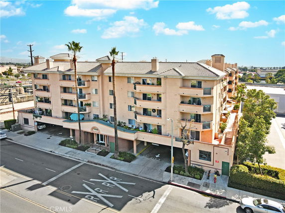 Front view of a multi-story residential building with balconies.