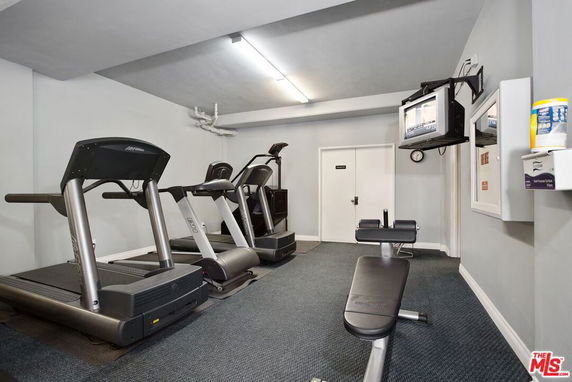 Indoor gym room with treadmills and exercise bench.