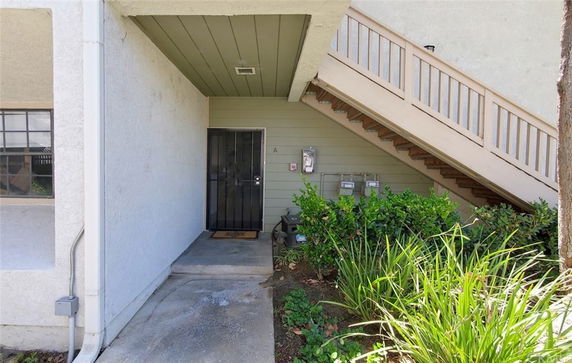 Entrance area of a building with a staircase leading to the upper floor.