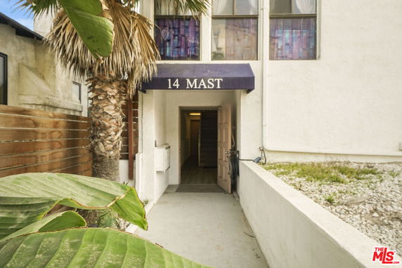 Entrance of a building with a blue canopy labeled '14 Mast'.