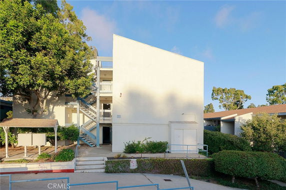 Front view of a multi-story building with external staircases.