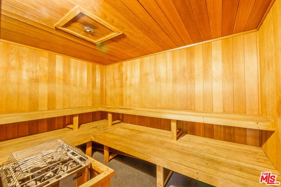 Interior of a wooden sauna room with benches and a heater.