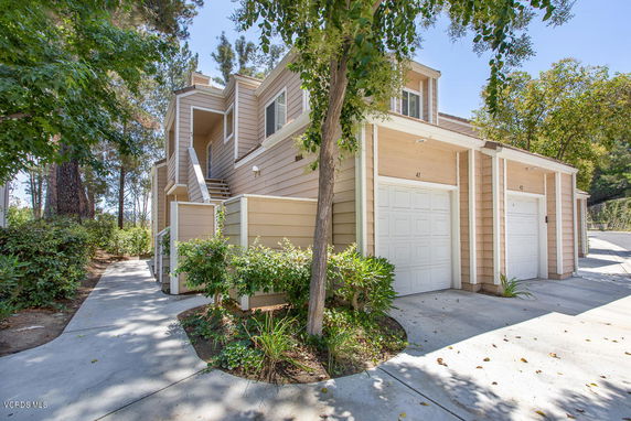 Front view of a two-story townhouse with a garage.