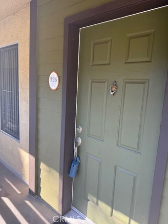 Front view of a building with a green door and a window.