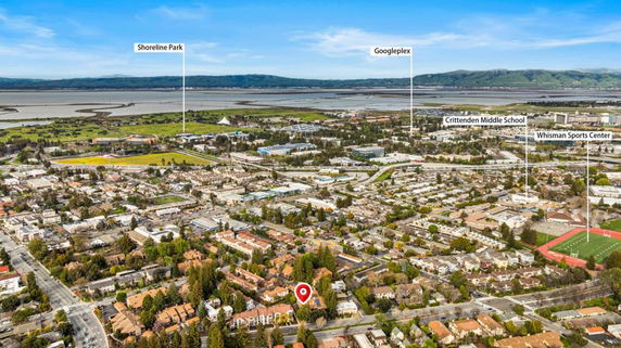 Panoramic view of a sprawling urban area with notable locations labeled, including Shoreline Park and Googleplex.