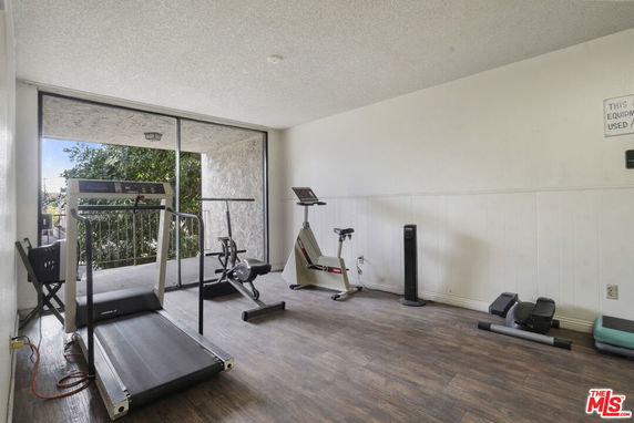 Indoor gym area with exercise equipment including treadmill and stationary bike.