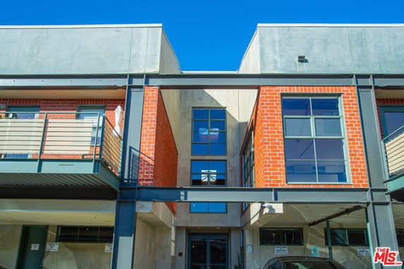 Front view of a building with modern brick and concrete design.