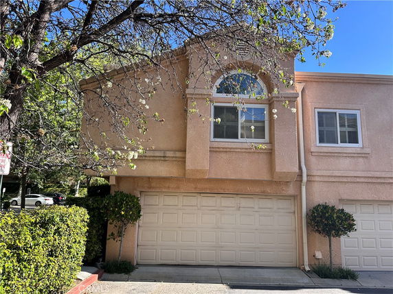 Front view of a two-story house with attached double garage.
