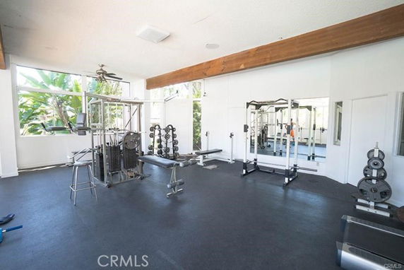 Indoor gym area equipped with weight machines and exercise equipment.