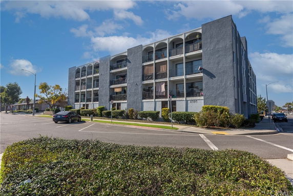 Front view of a multi-story residential building with balconies.