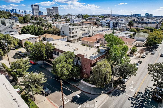 Aerial view of an urban area with multiple residential buildings lined along the streets.