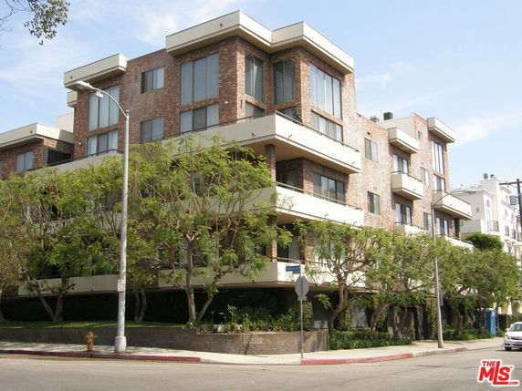 Front view of a multi-story brick apartment building.