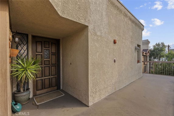 Front view of a house with a wooden door and outdoor entryway