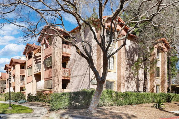 Front view of a multi-story apartment building with balconies.