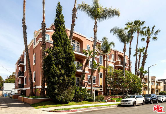 Front view of a multi-story residential building with balconies.