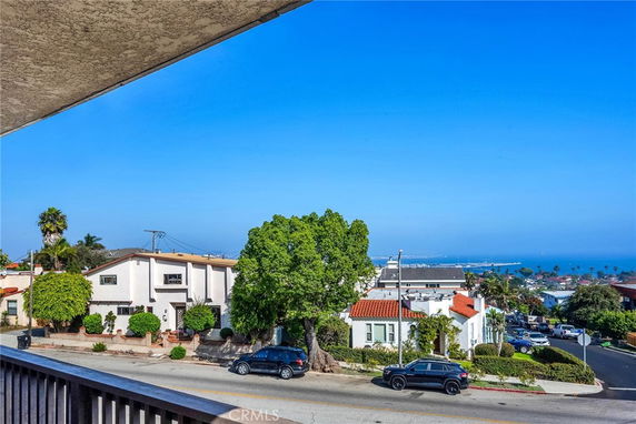 Panoramic view of a residential area with ocean in the background.