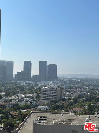 Panoramic view of a cityscape with tall buildings and residential areas.